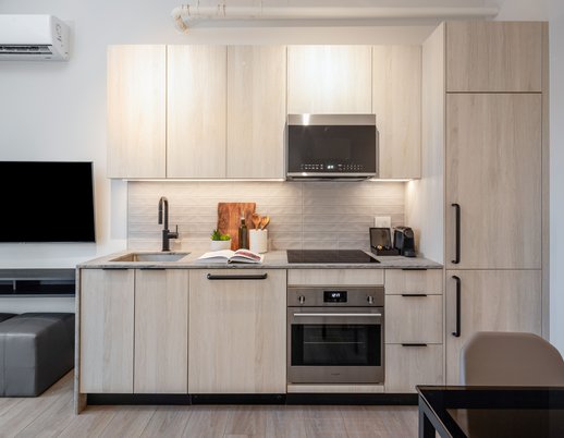 fully equipped kitchen of one bedroom suite at steveston waterfront hotel featuers premium appliances and nespresso machine