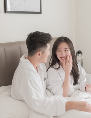 a couple still in bed having a morning conversation at steveston waterfront hotel