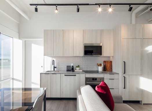 waterfront one bedroom suite at steveston waterfront hotel features living area, fully equipped kitchen and beautiful waterfront view of steveston village